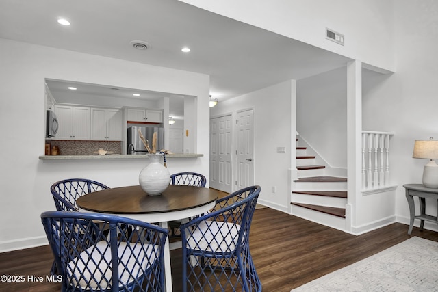 dining room with recessed lighting, visible vents, wood finished floors, and stairway