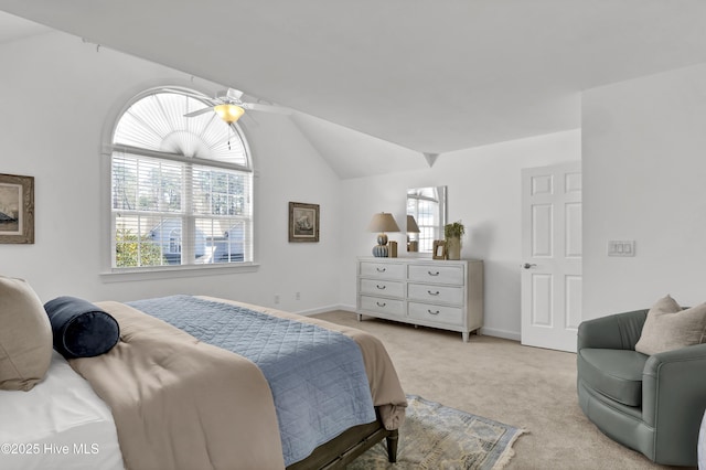 bedroom with a ceiling fan, lofted ceiling, light colored carpet, and baseboards