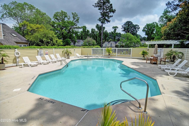 community pool with fence, a patio area, and a pergola