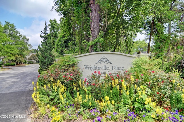 community / neighborhood sign with aphalt driveway