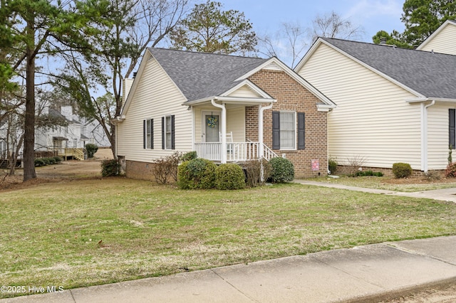 view of front of home featuring a front lawn, brick siding, and a shingled roof