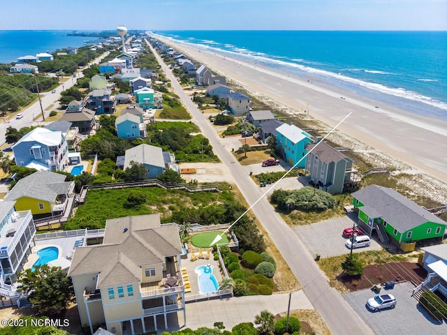 birds eye view of property featuring a view of the beach and a water view