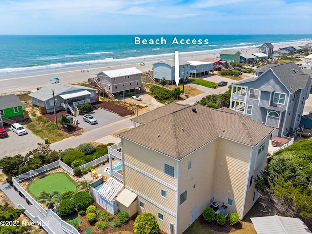 bird's eye view with a residential view, a water view, and a view of the beach