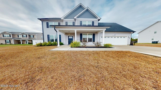 view of front of property with a front yard, driveway, an attached garage, central air condition unit, and board and batten siding