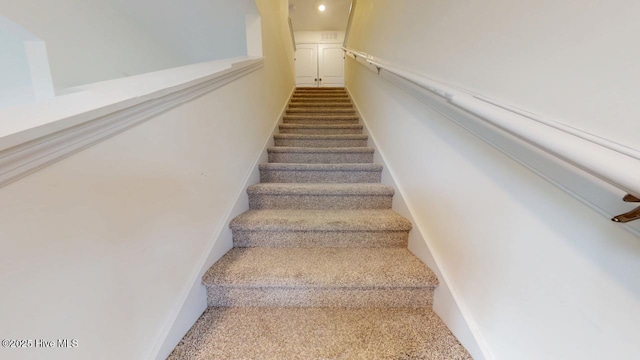 stairway featuring baseboards