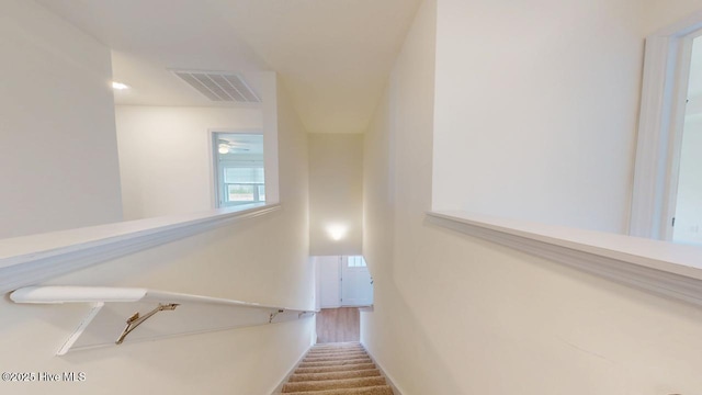 stairs with baseboards and visible vents