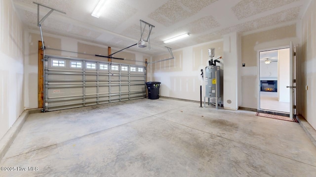 garage with a garage door opener and electric water heater