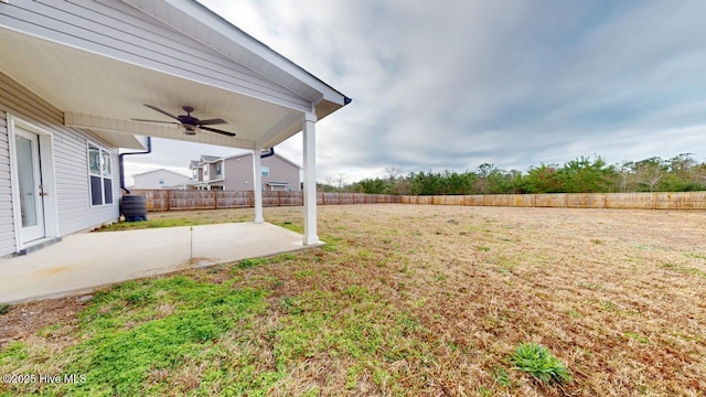 view of yard featuring a fenced backyard, ceiling fan, and a patio area