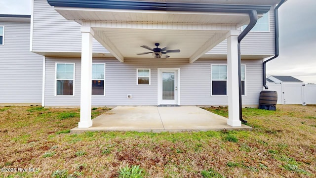 exterior space featuring a ceiling fan and fence