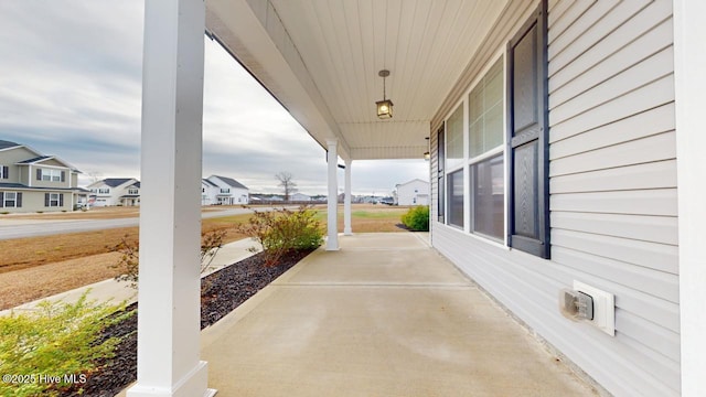 view of patio / terrace with a residential view and covered porch