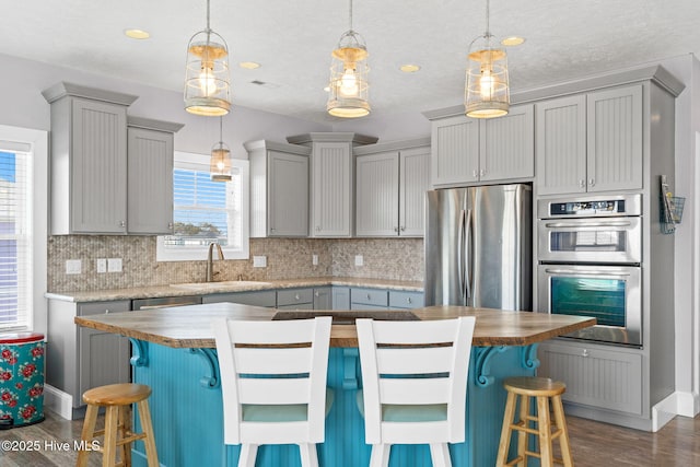 449 E Fourth St, Ocean Isle Beach, NC 28469 - kitchen with stainless steel appliances, dark wood-style floors, a sink, backsplash, and recessed lighting