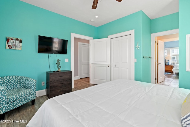 449 E Fourth St, Ocean Isle Beach, NC 28469 - bedroom with baseboards, wood finished floors, a closet, and ceiling fan