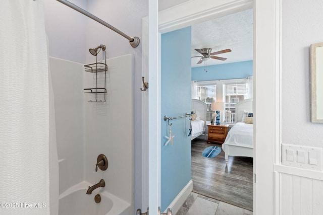 449 E Fourth St, Ocean Isle Beach, NC 28469 - ensuite bathroom with shower / tub combo, ceiling fan, and baseboards