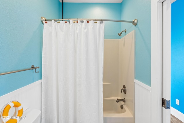 449 E Fourth St, Ocean Isle Beach, NC 28469 - full bathroom featuring a wainscoted wall, shower / tub combo with curtain, and toilet