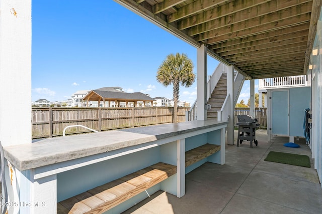 449 E Fourth St, Ocean Isle Beach, NC 28469 - fenced backyard featuring stairway, a patio area, and a grill