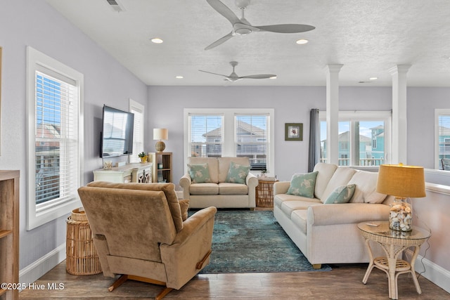 449 E Fourth St, Ocean Isle Beach, NC 28469 - living room featuring ornate columns, plenty of natural light, a ceiling fan, wood finished floors, and recessed lighting