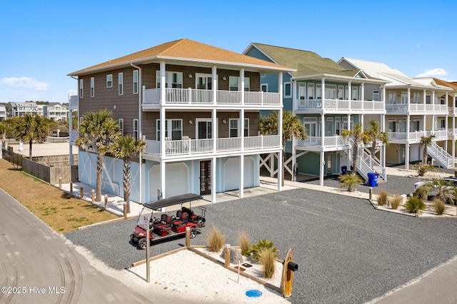 449 E Fourth St, Ocean Isle Beach, NC 28469 - view of apartment building / complex with an attached garage and driveway