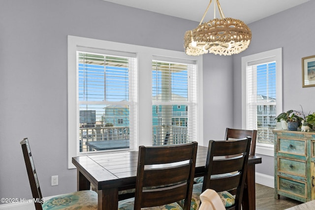 449 E Fourth St, Ocean Isle Beach, NC 28469 - dining area featuring a chandelier, wood finished floors, and baseboards