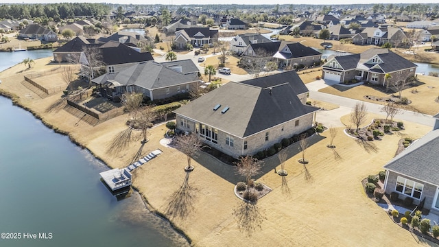 aerial view featuring a residential view and a water view