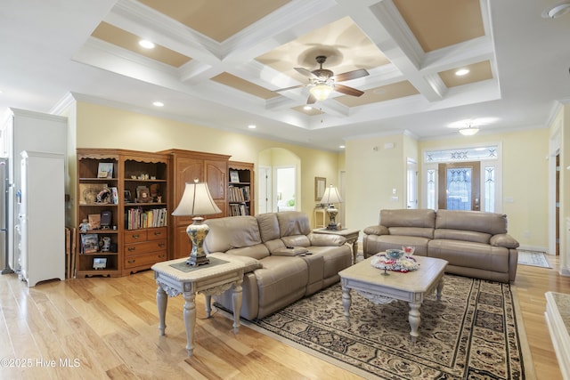 living room with a wealth of natural light, arched walkways, light wood-style floors, and coffered ceiling