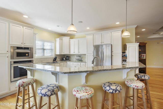 kitchen featuring white cabinetry, crown molding, light wood finished floors, and appliances with stainless steel finishes