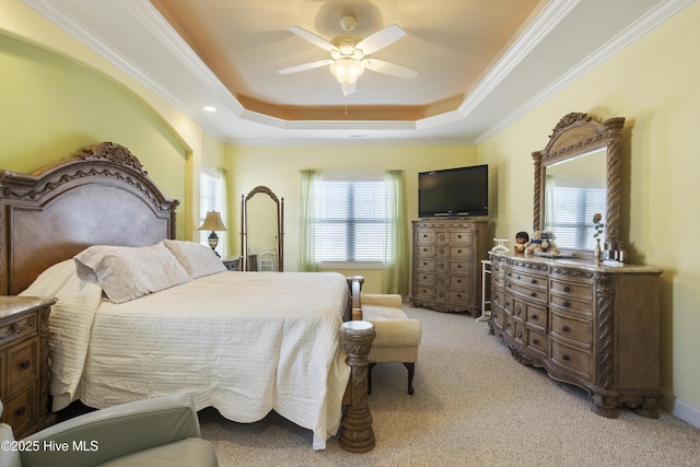 bedroom featuring light carpet, a raised ceiling, a ceiling fan, and crown molding