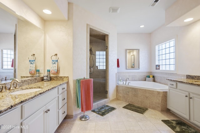 bathroom with vanity, visible vents, a shower stall, a garden tub, and tile patterned floors