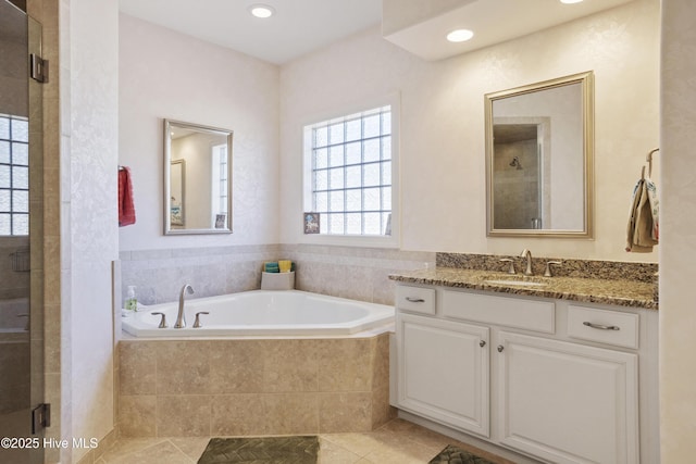 bathroom featuring tile patterned floors, a stall shower, recessed lighting, a bath, and vanity