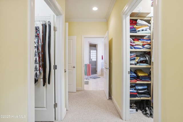 hallway featuring carpet flooring, recessed lighting, baseboards, and ornamental molding