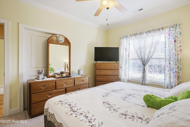 bedroom featuring visible vents, baseboards, light colored carpet, ornamental molding, and a ceiling fan