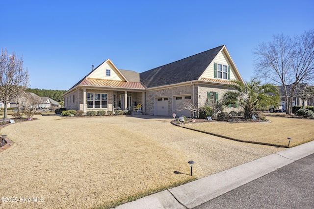 view of front of home with a standing seam roof, brick siding, dirt driveway, and metal roof