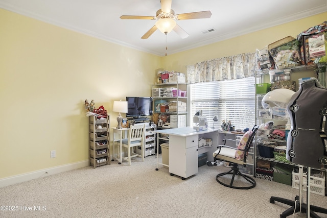 carpeted office space featuring visible vents, baseboards, a ceiling fan, and crown molding