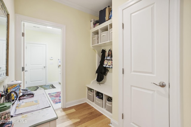 mudroom with light wood finished floors and baseboards