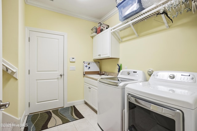 washroom with light tile patterned floors, cabinet space, separate washer and dryer, a sink, and crown molding