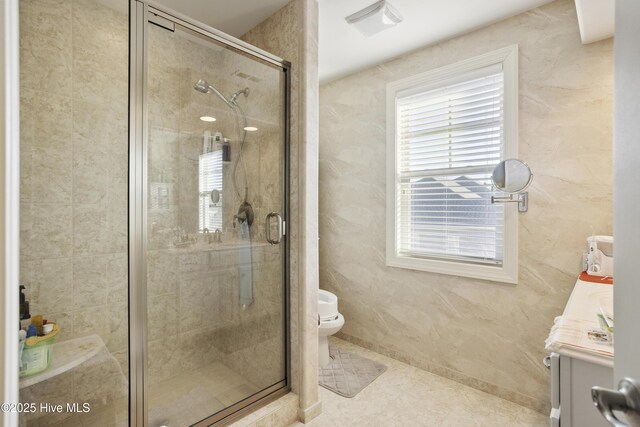 bathroom with tile patterned floors, toilet, a stall shower, and vanity