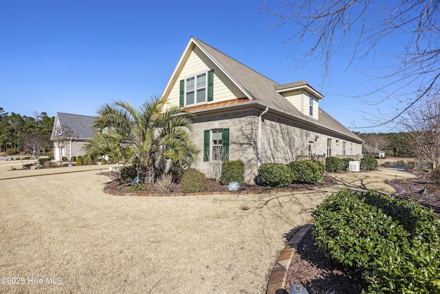 view of side of home featuring brick siding