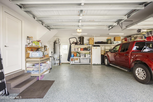 garage with water heater, refrigerator, and a garage door opener