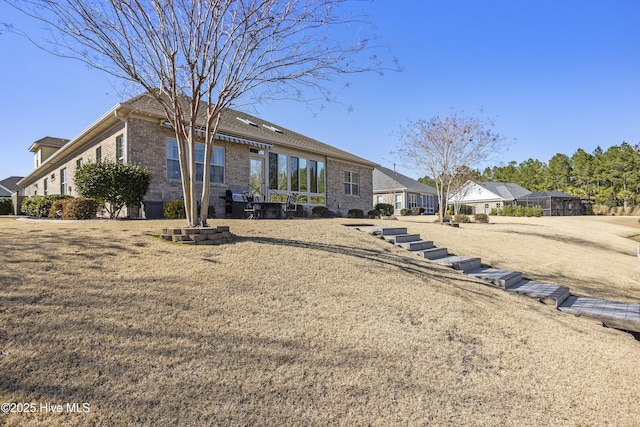 rear view of property featuring brick siding