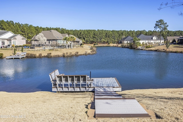 view of dock with a residential view and a water view