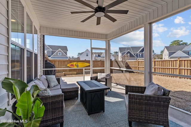 view of patio / terrace featuring a residential view, ceiling fan, outdoor lounge area, and a fenced backyard