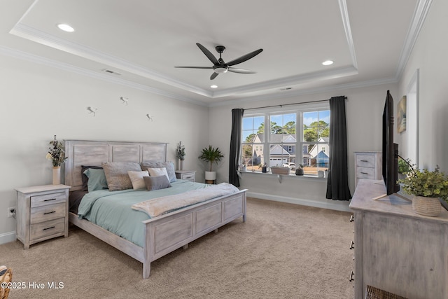 bedroom with light carpet, visible vents, a raised ceiling, and baseboards