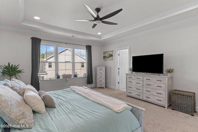 bedroom with light carpet, a tray ceiling, and ornamental molding