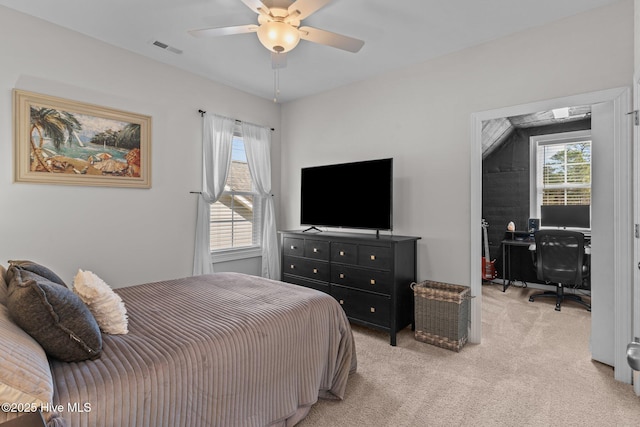 bedroom with visible vents, light carpet, and ceiling fan