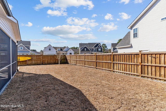 view of yard featuring a residential view and a fenced backyard