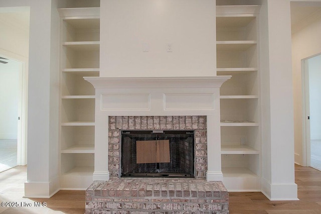 interior details with built in features and a brick fireplace