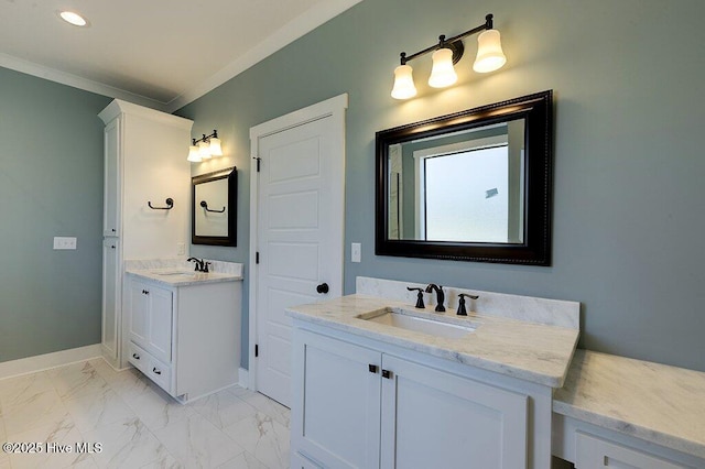 bathroom featuring a sink, baseboards, marble finish floor, and ornamental molding