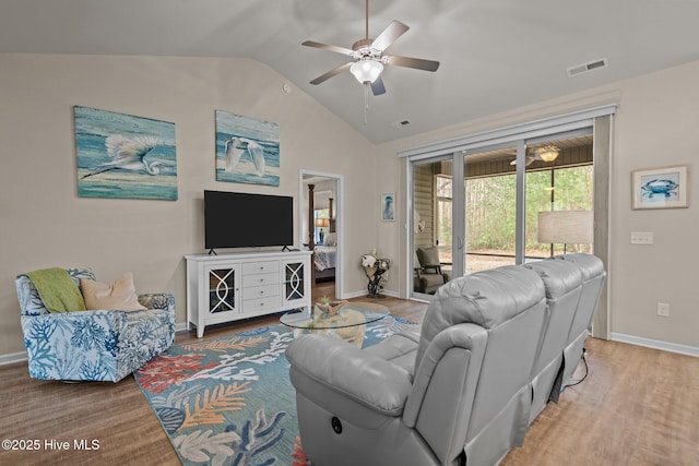 living room with lofted ceiling, wood finished floors, visible vents, and ceiling fan