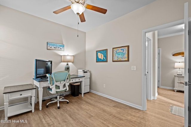 office space featuring light wood finished floors, baseboards, and a ceiling fan