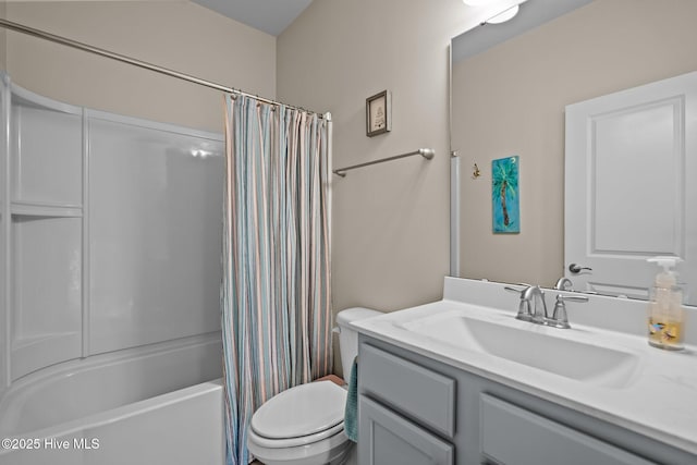 bathroom with shower / bath combination with curtain, toilet, and vanity