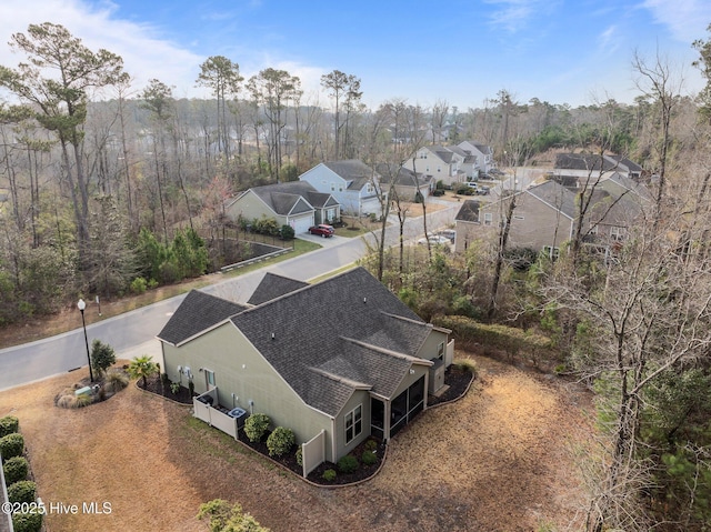 birds eye view of property with a forest view and a residential view